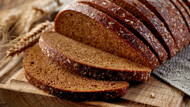 Sliced rye bread on cutting board