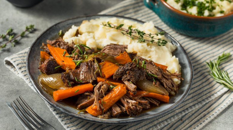 plate of shredded pot roast with mashed potatoes