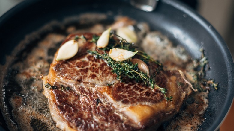 sizzling steak in pan