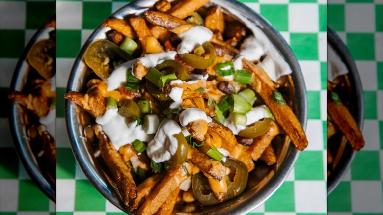 Boise Fry Co. loaded fries on a white and green table