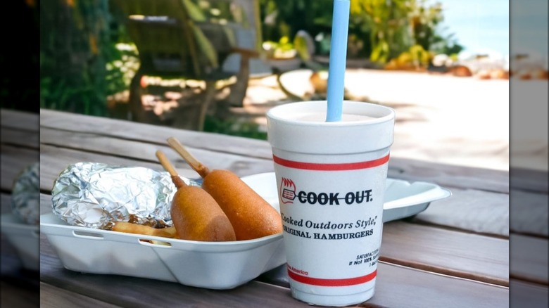 CookOut corn dogs and a drink on a picnic table outside