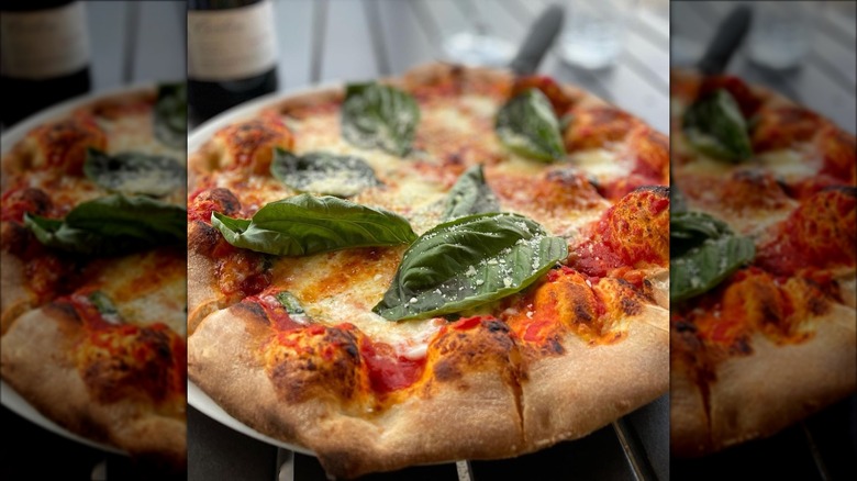 margherita pizza topped with basil