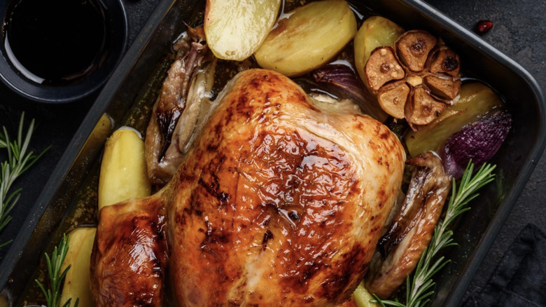 turkey and vegetables in roasting pan