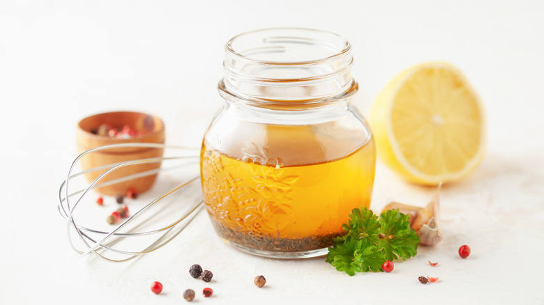 jar of italian dressing and fresh ingredients