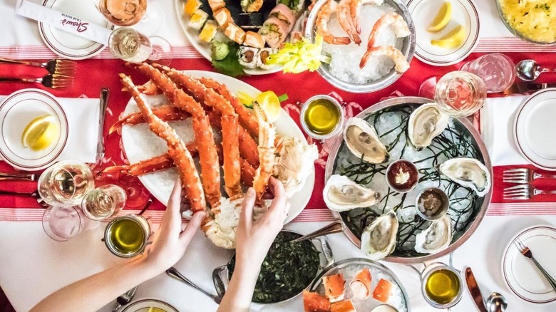 Seafood feast with crab legs, oysters, and sushi