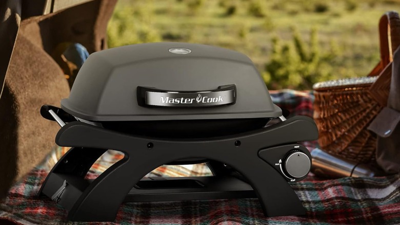 Master Cook Tabletop Gas Grill sitting on a blanket in the back of a vehicle