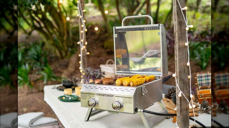 Megamaster Premium Outdoor Cooking 2-Burner Grill sitting outside on a table