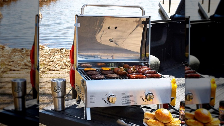 Pit Boss 75275 Stainless Steel Portable Grill sitting outside by a lake