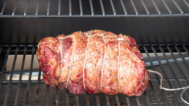 Beef slow-cooking in a smoker