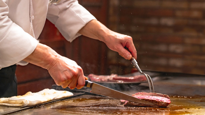 teppanyaki chef cooking steak