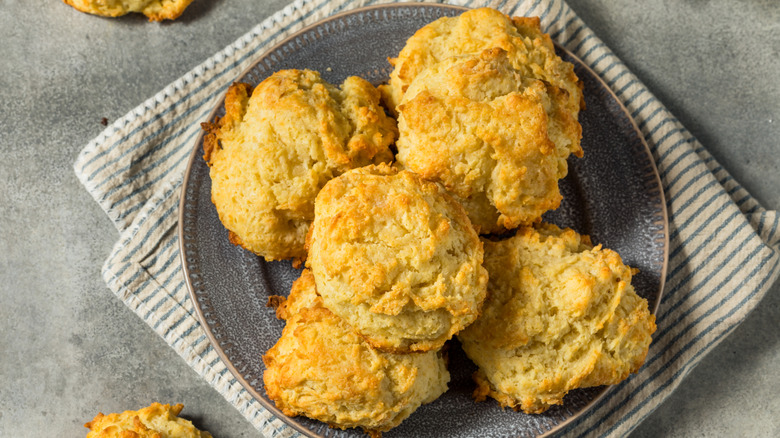Buttery drop biscuits on a dark plate
