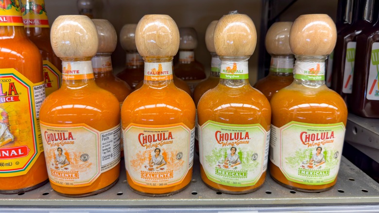 Bottles of Cholula sauce on a store shelf