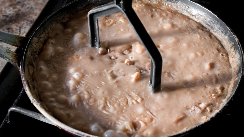 Making refried beans in pan 