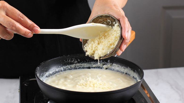 Cheese being added into a roux