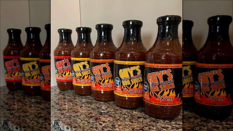 A row of Guy's BBQ sauce bottles.