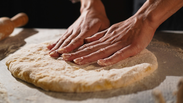 chef making pizza dough