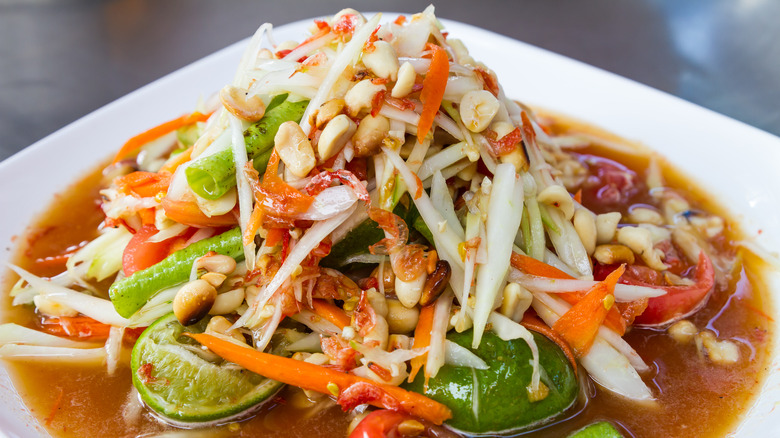 Thai papaya salad on a white plate