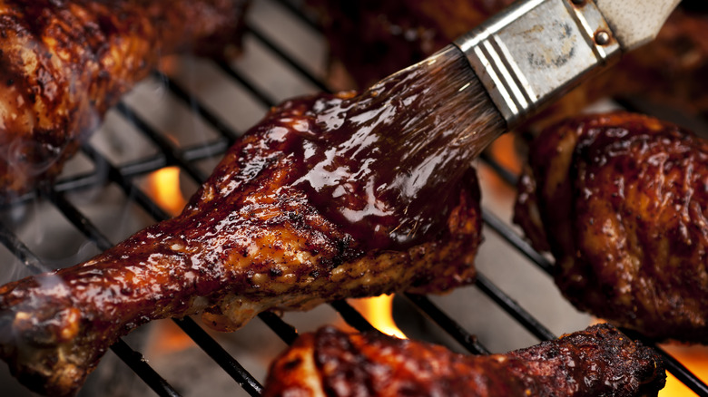 chicken legs barbecue grill basting with sauce