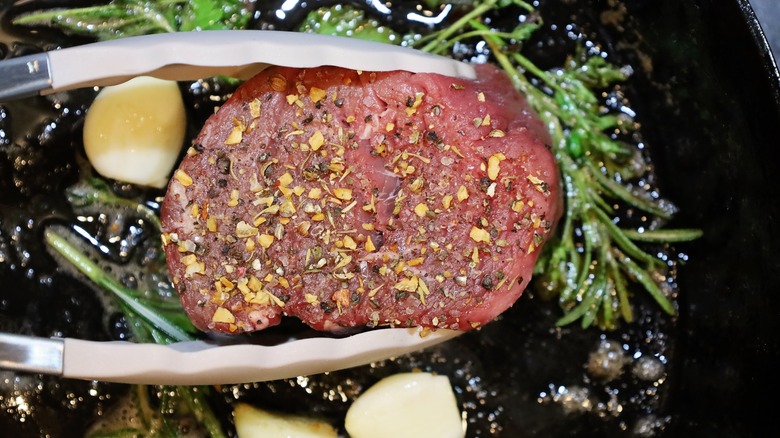 Steak cooking in pan