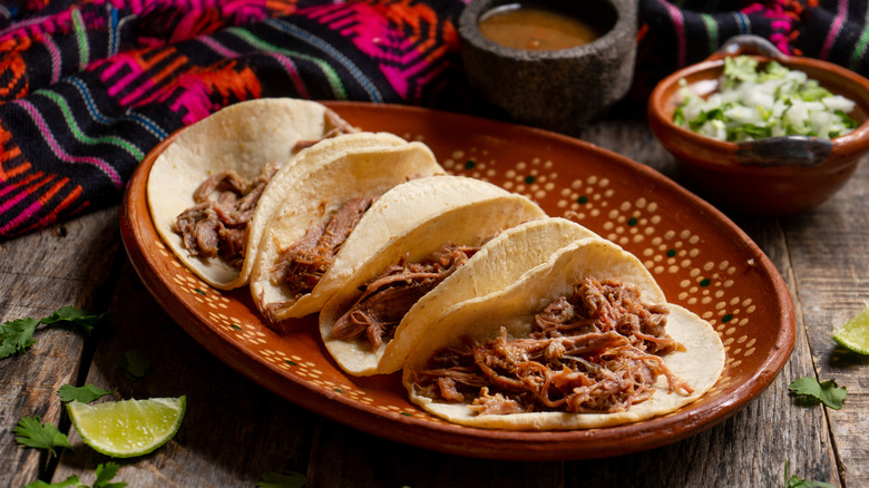 barbacoa tacos on traditional Mexican plate