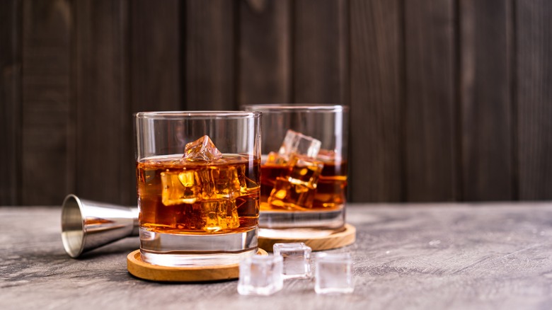 Two glasses of bourbon and ice