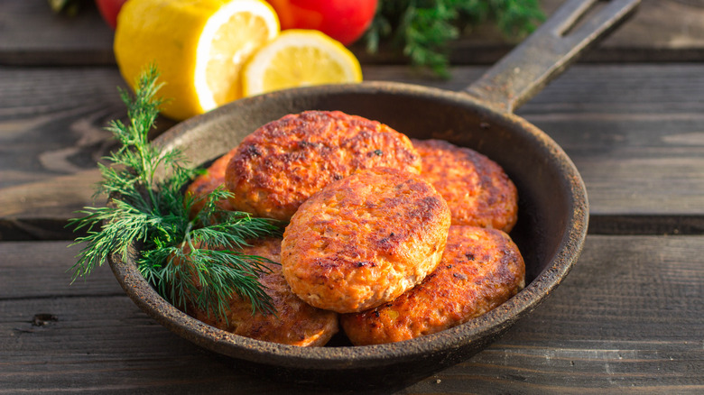 Salmon cakes on frying pan