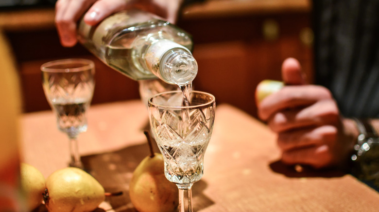 Pouring gin into a glass