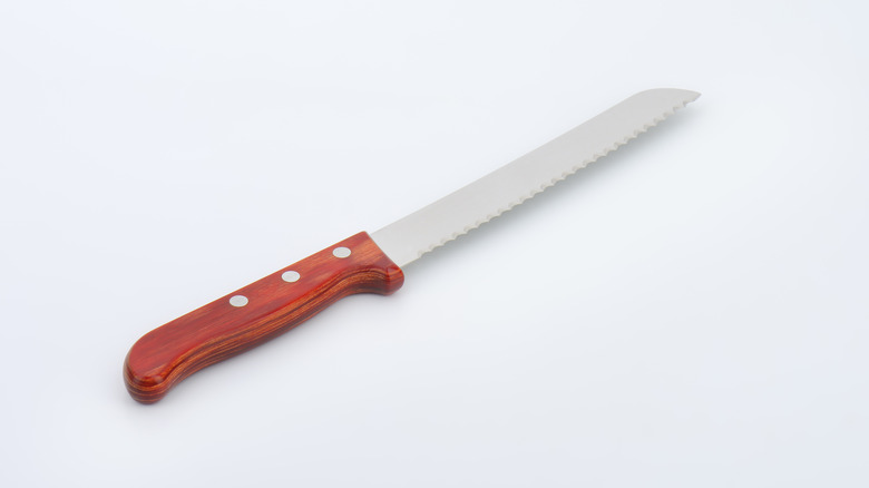 Serrated knife with wood handle