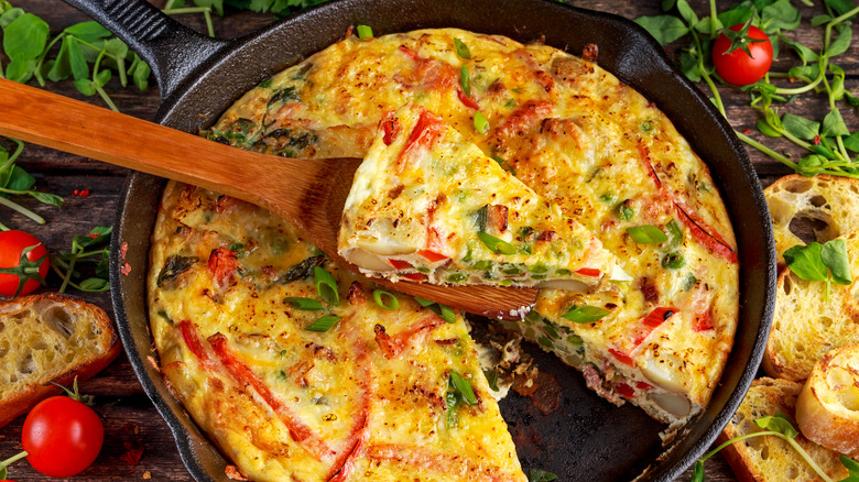 Frittata being served from cast-iron pan