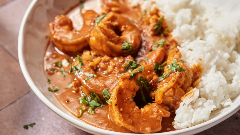 Bowl of shrimp tikka masala with rice