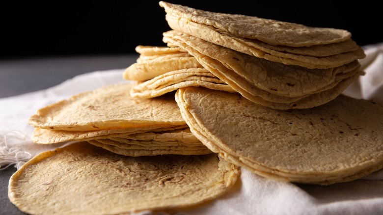 corn tortillas stacked on cloth