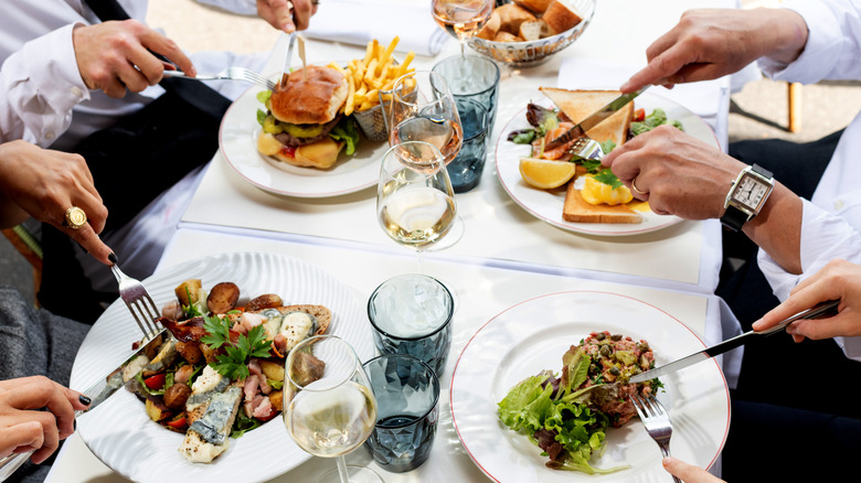 diners, with steak tartare and white wine