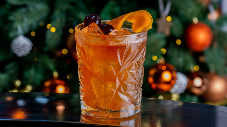 old fashioned cocktail in front of Christmas tree