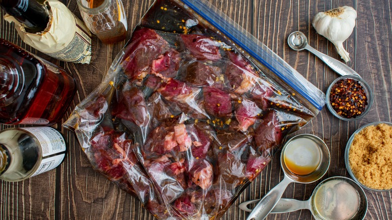 red meat marinating in a plastic bag