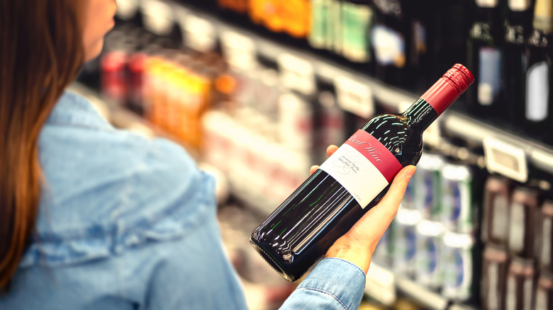 Woman holding a wine bottle