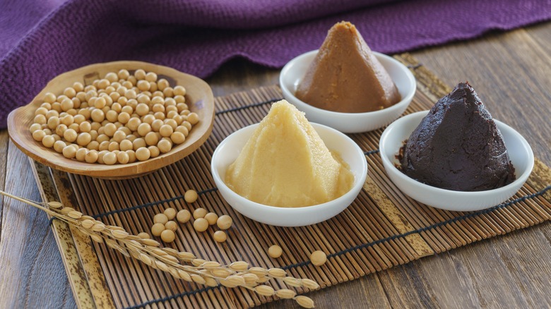 Miso paste varieties next to a plate of soybeans