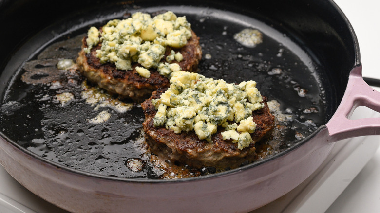 cooking blue cheese topped patties