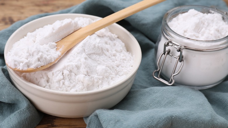 A wooden spoon in a bowl of cornstarch