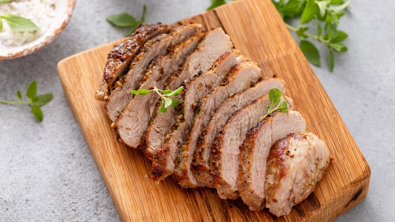 Sliced pork chop on cutting board