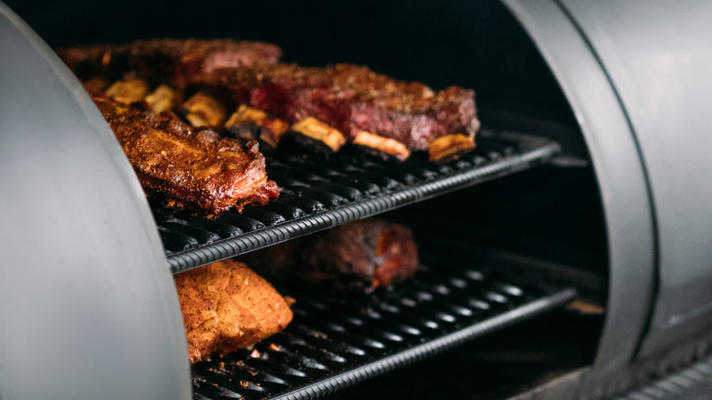 Ribs and meat on smoker