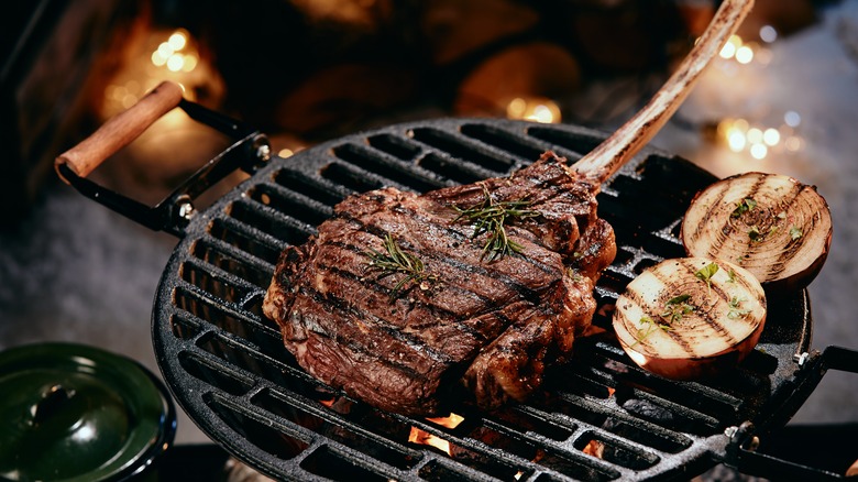 Bone in steak on grill 