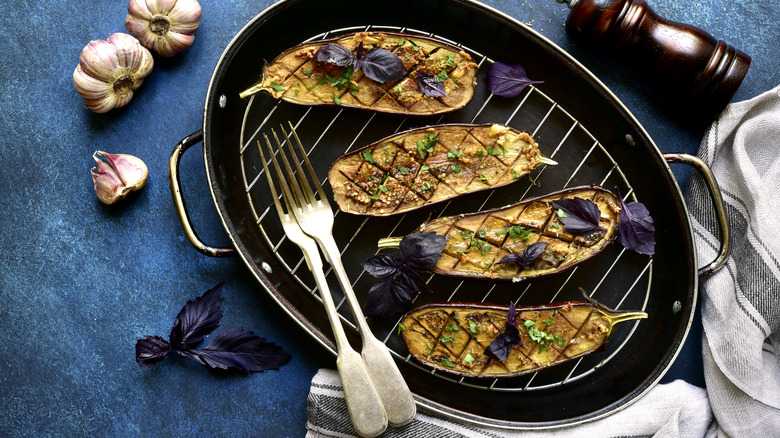 eggplant halves sitting on the grill