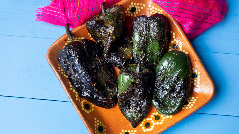 blistered and charred whole poblanos on plate