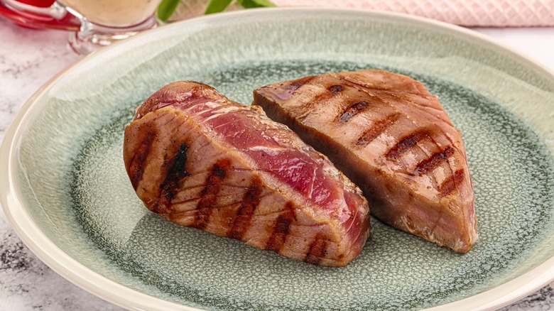 grilled tuna steaks with sauce on a plate