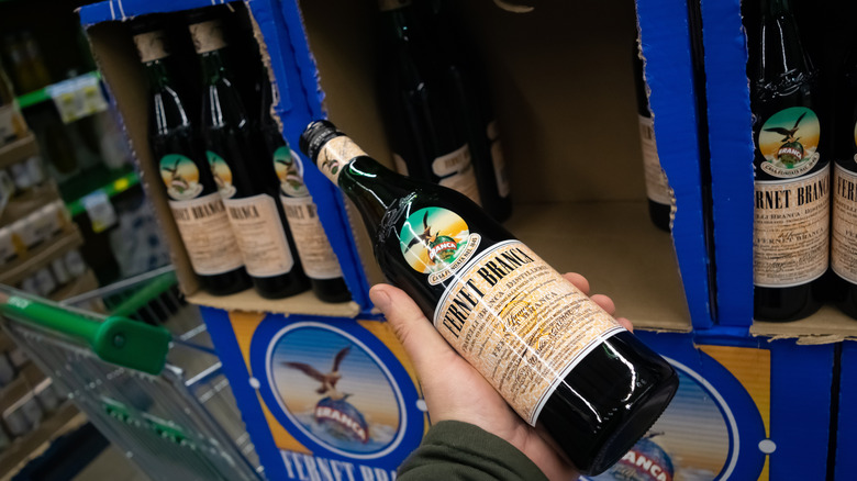 Hand holding Fernet-Branca in store