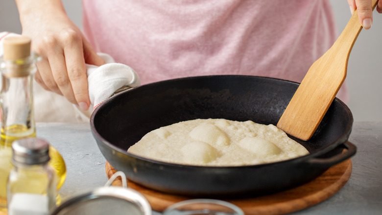 Man cooks flour tortilla