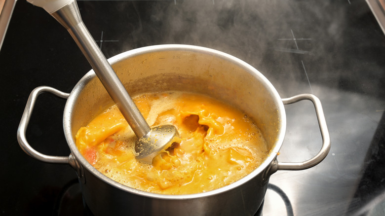 immersion blender in pot of soup