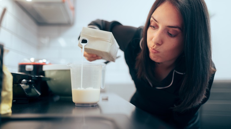 Pouring milk into measuring cup