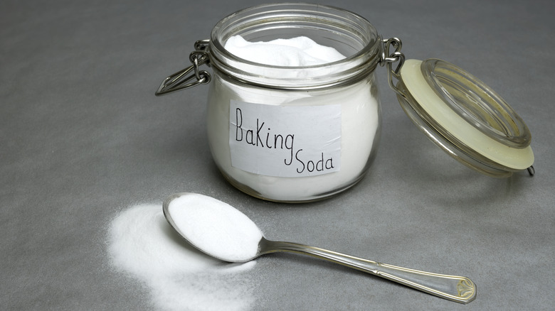 Baking soda in an open jar with a spoon