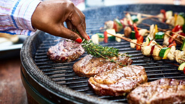 seasoning grilled steaks with thyme